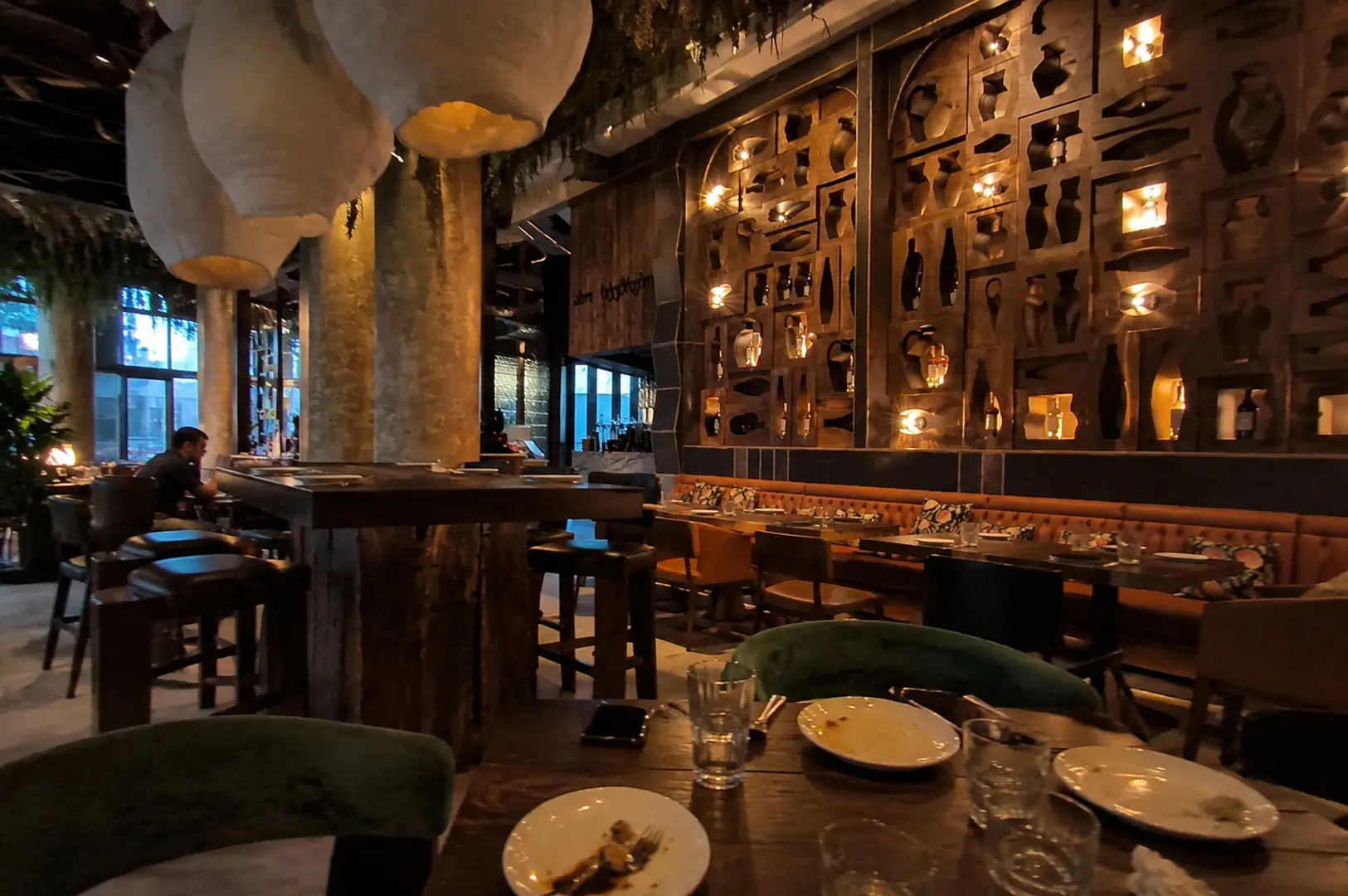 Atmospheric restaurant interior featuring a decorative wall niche display and warm lighting