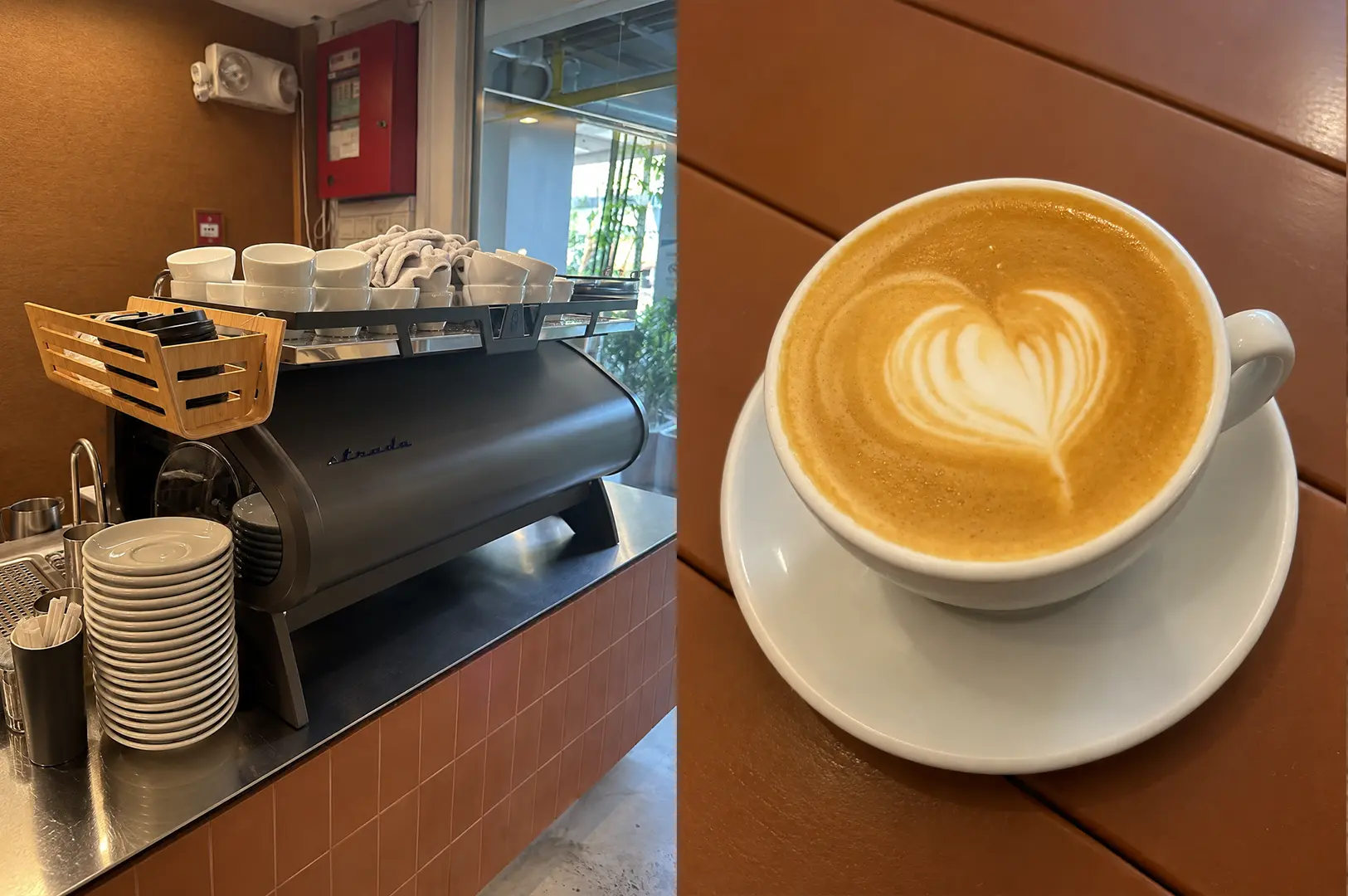 Espresso machine counter with a freshly made latte in a white cup.
