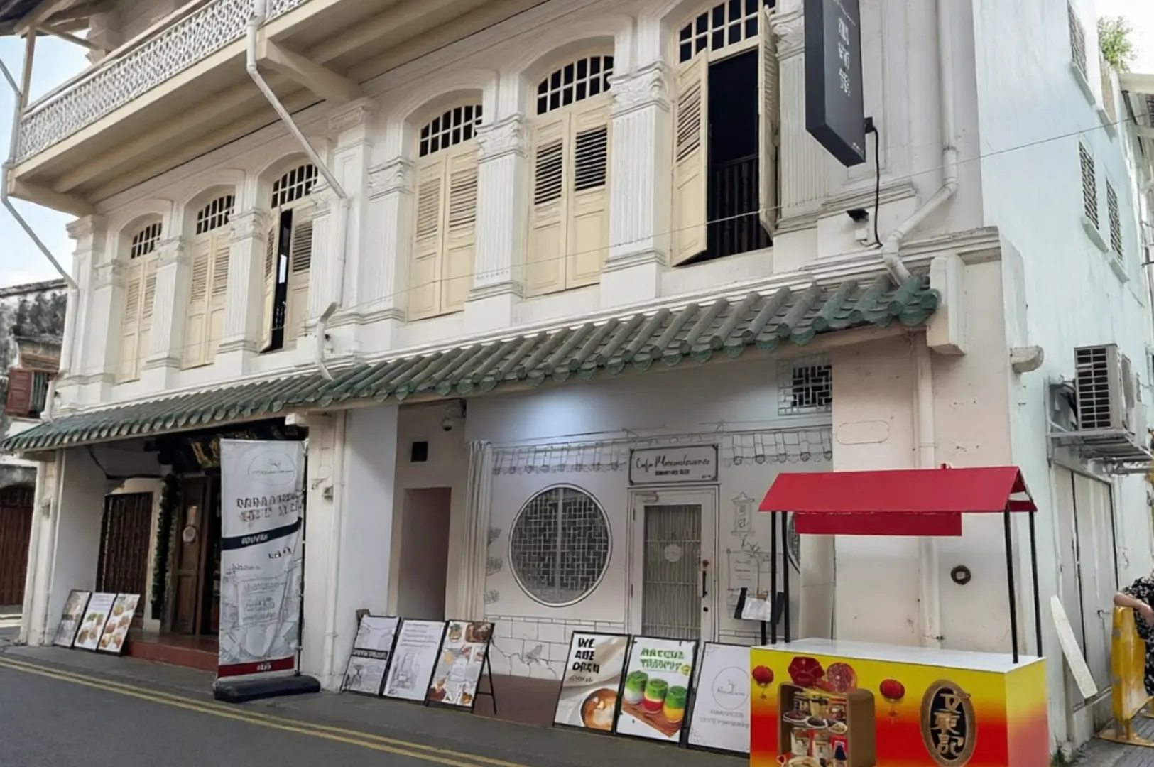 White colonial shophouse exterior on Smith Street with Café Monochrome signage, red awning, and menu boards