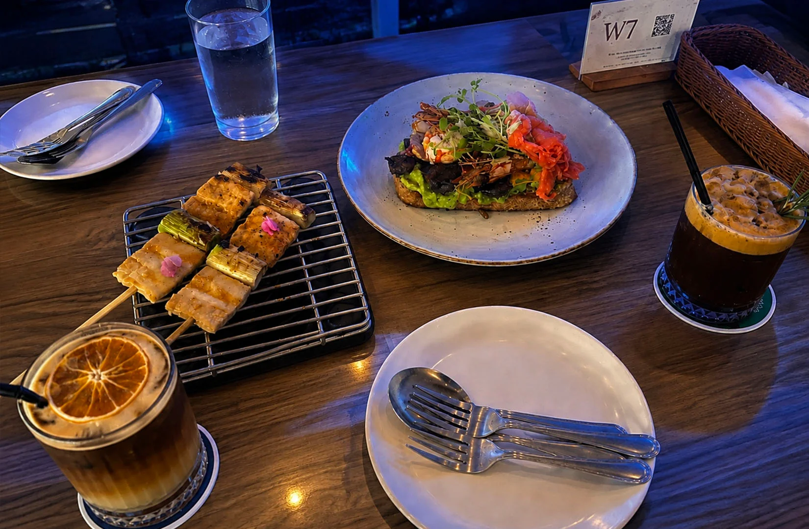 Café table with coffee drinks and plated appetizers