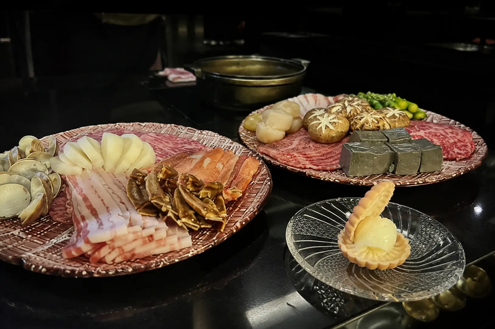 Japanese hot pot ingredients including premium beef, seafood, mushrooms, vegetables, and ice cream dessert.