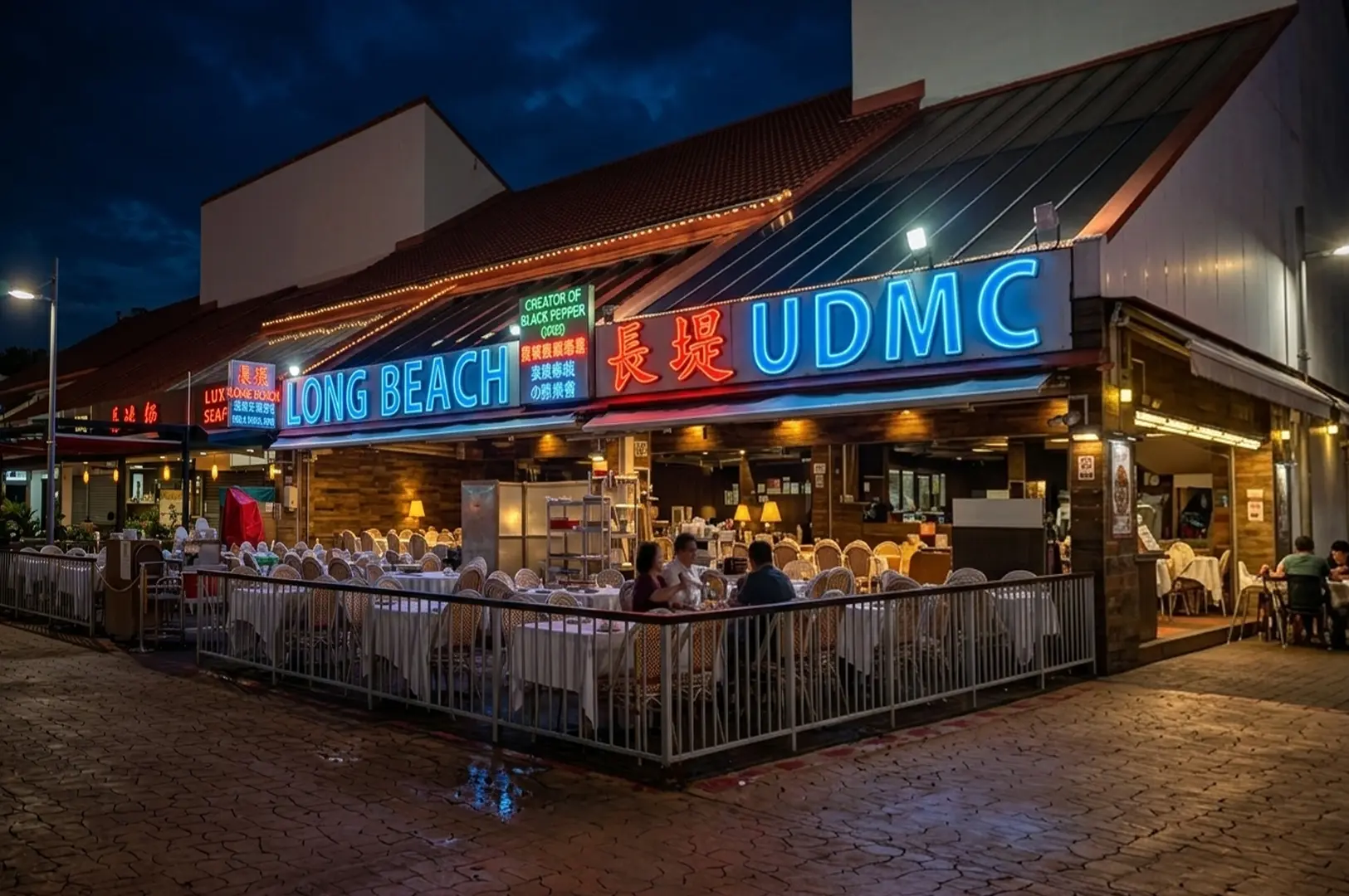 Night view of Long Beach seafood restaurant with neon signage and outdoor dining