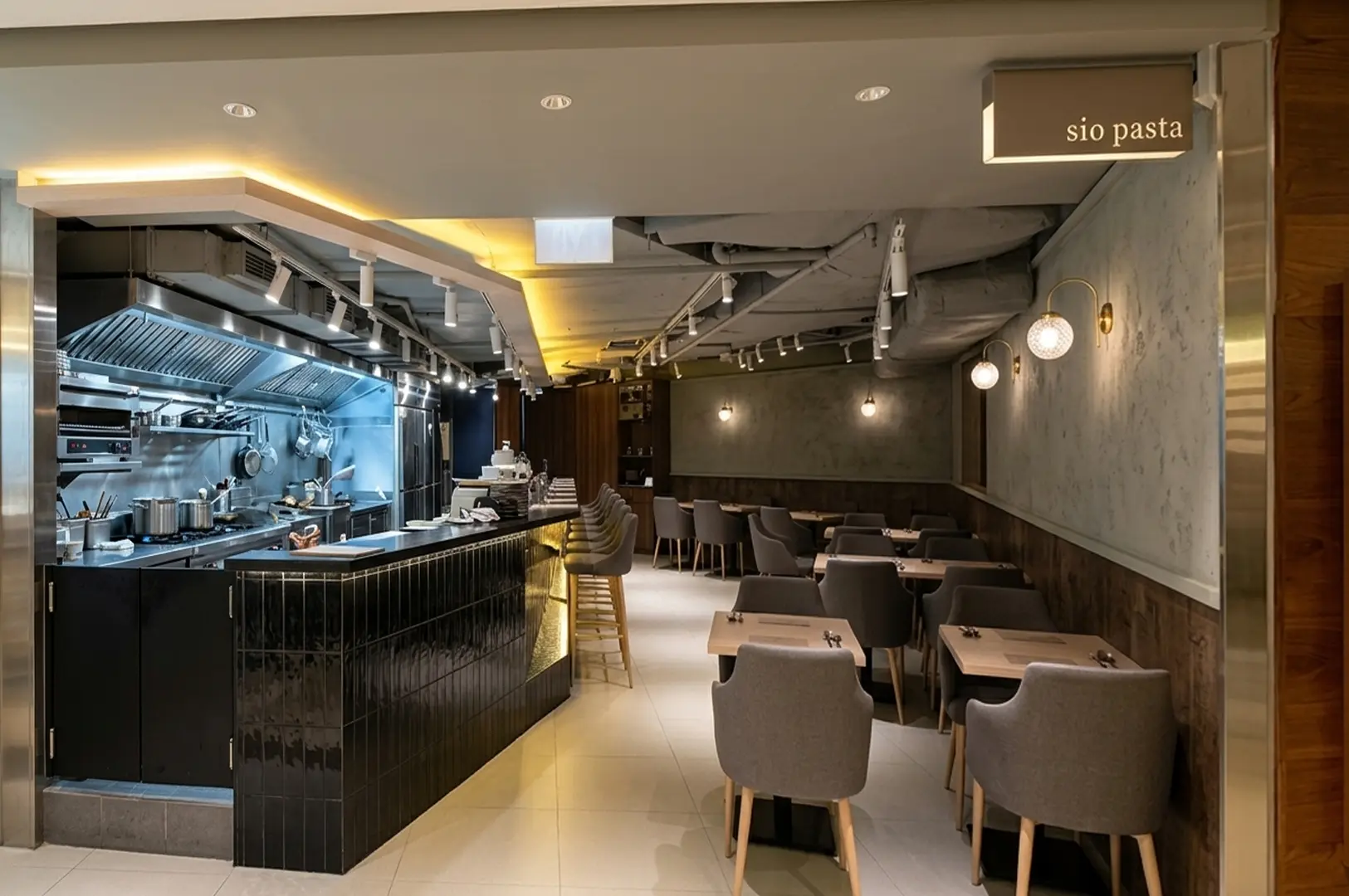 Interior of Sio Pasta restaurant featuring an open kitchen and modern dining area
