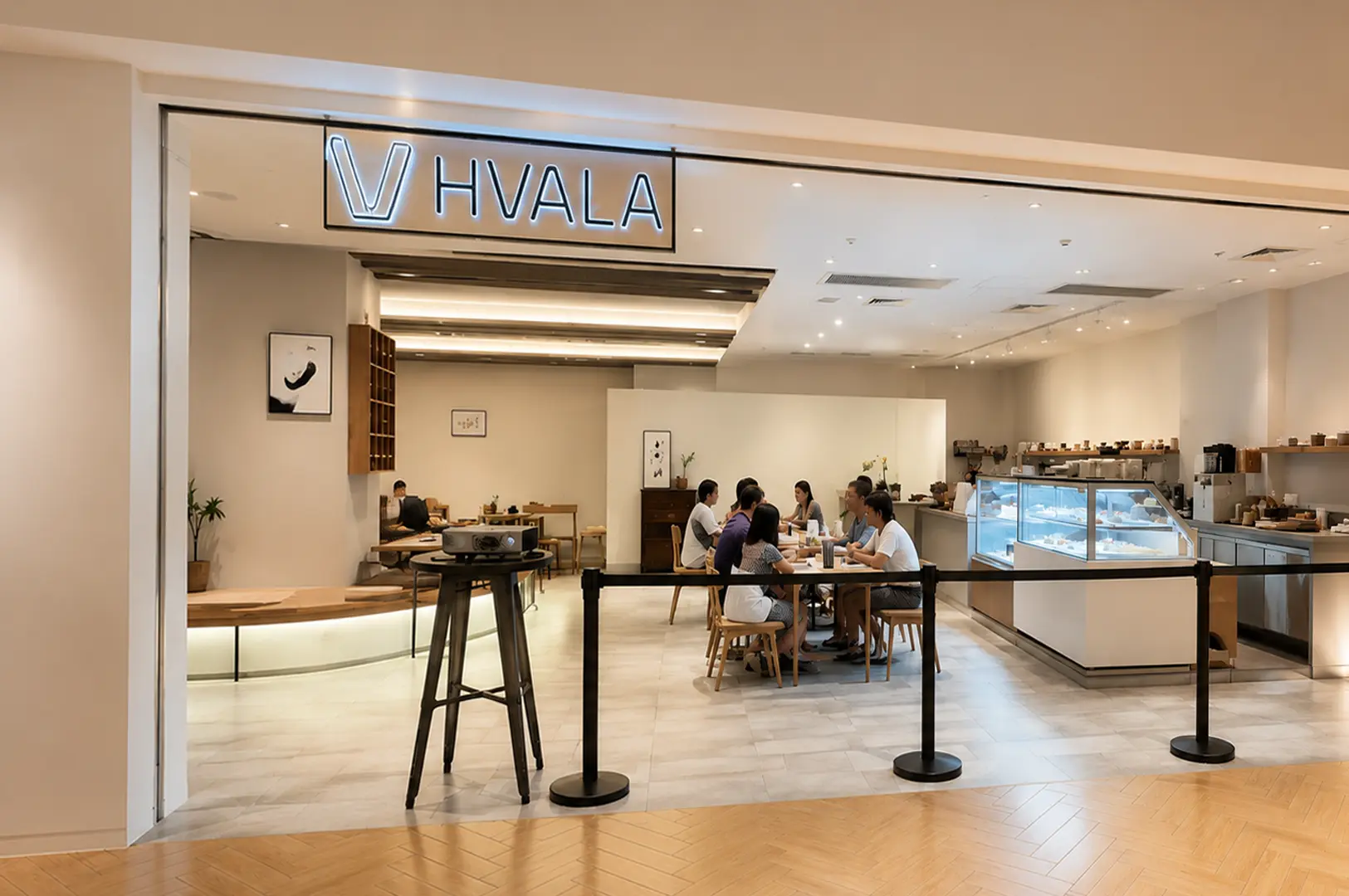 Hvala cafe storefront with neon sign and bright interior