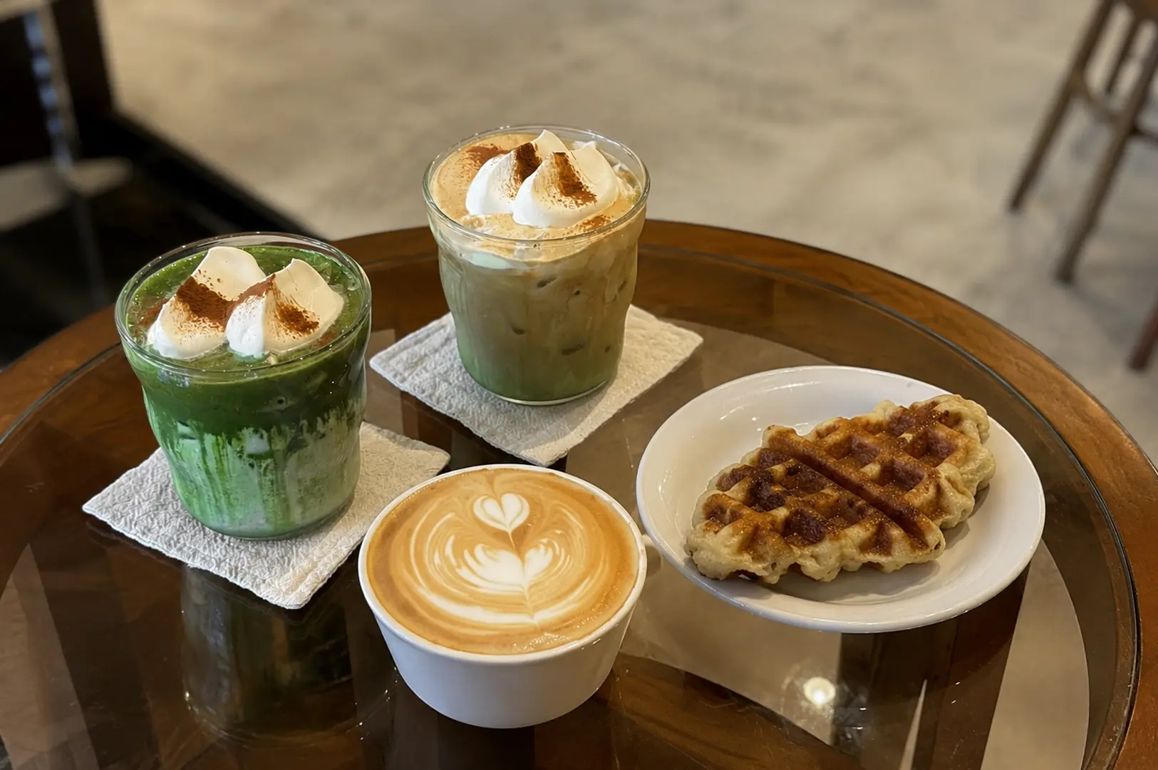 Aesthetic cafe drinks with latte art and waffle