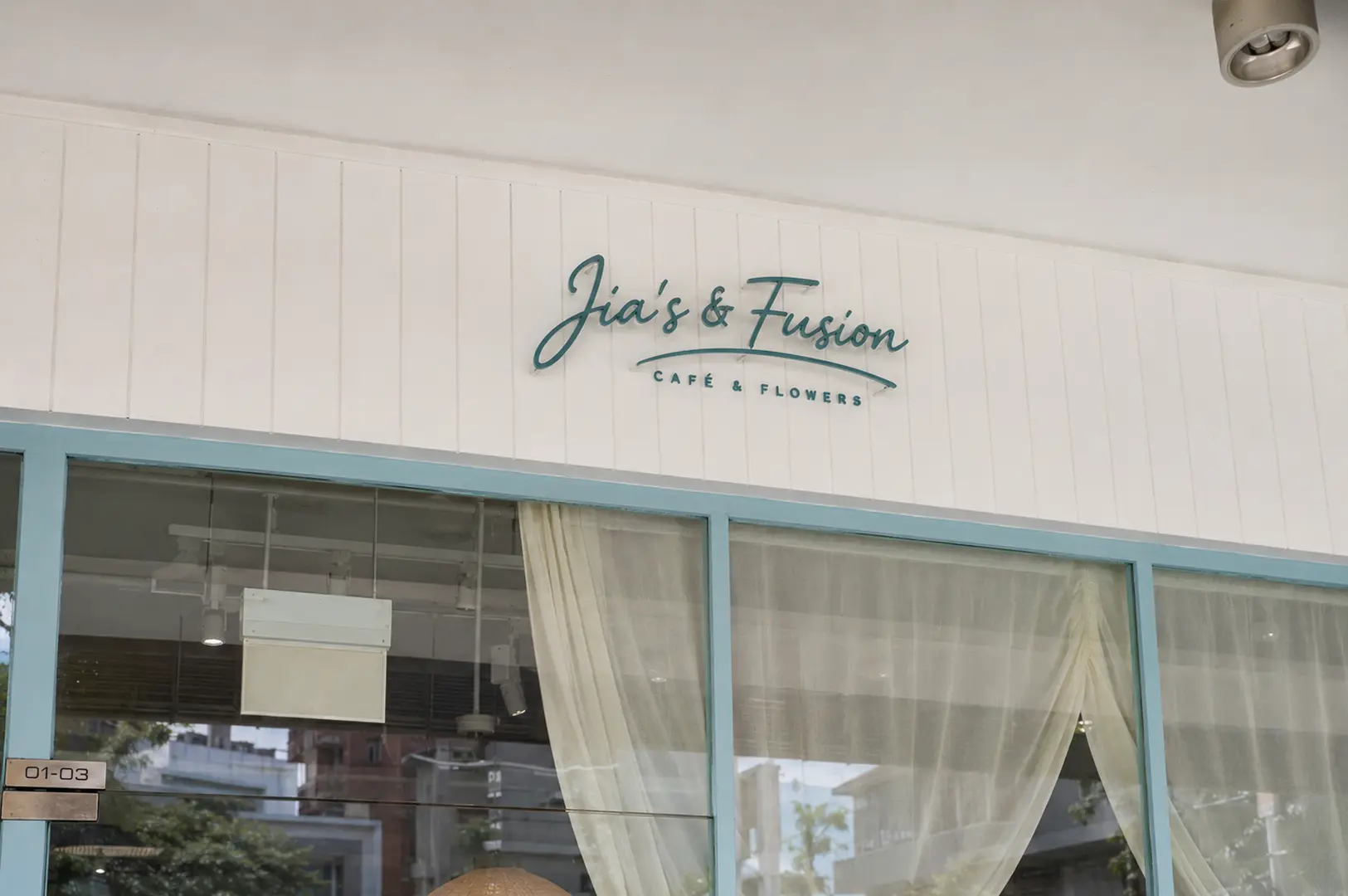 Storefront sign for Jia's & Fusion cafe and flowers