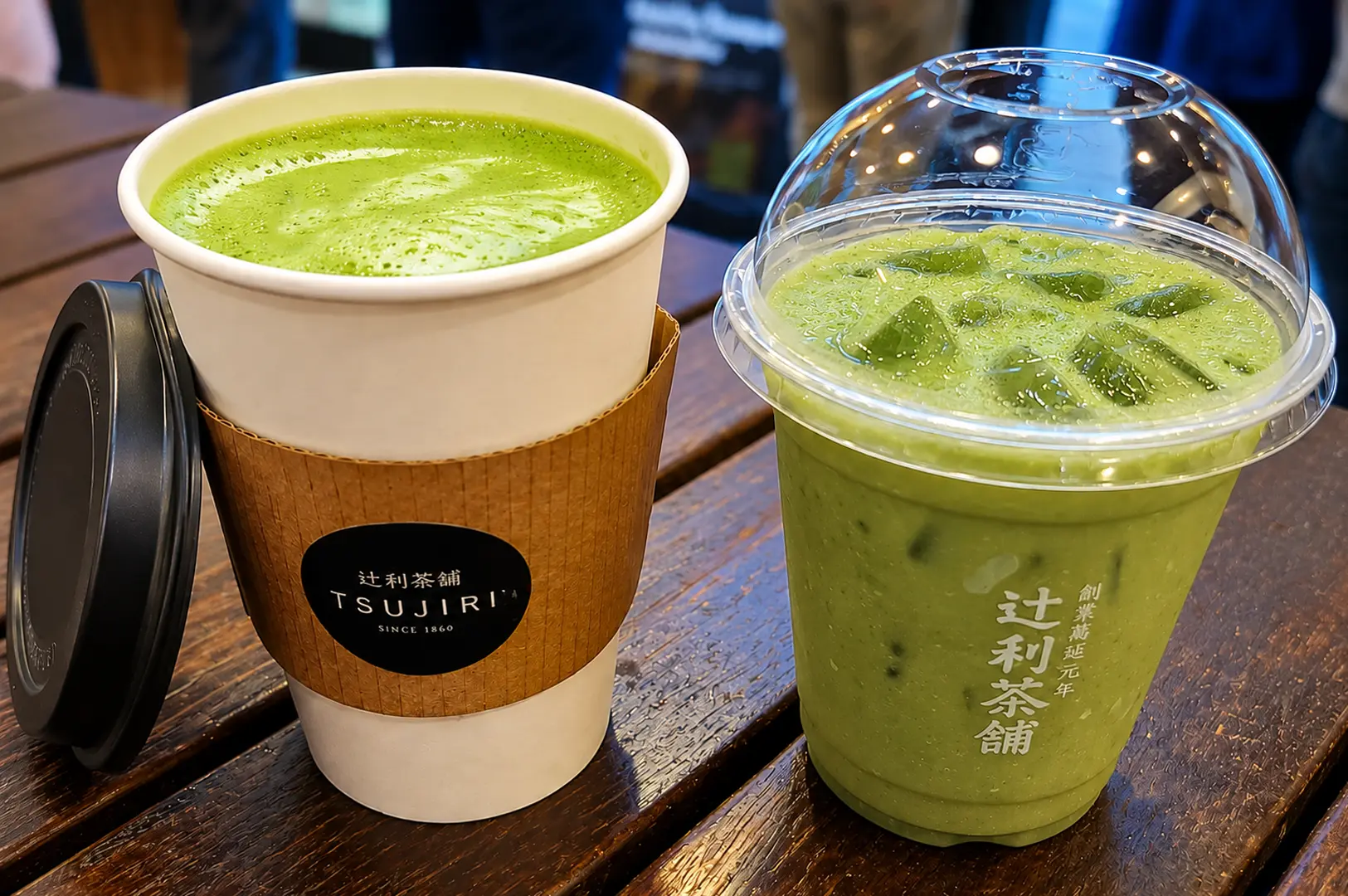 Hot and iced matcha drinks from Tsujiri cafe sitting on a wooden table