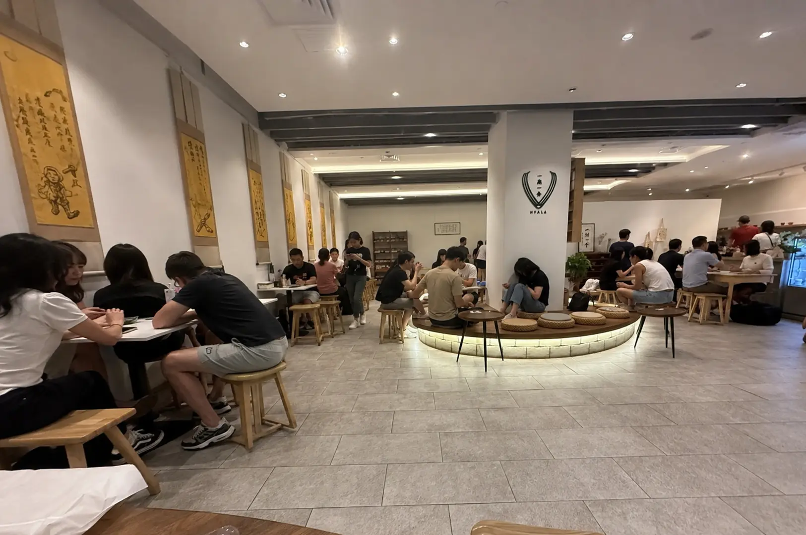 Busy interior of Hvala cafe with customers and minimalist decor