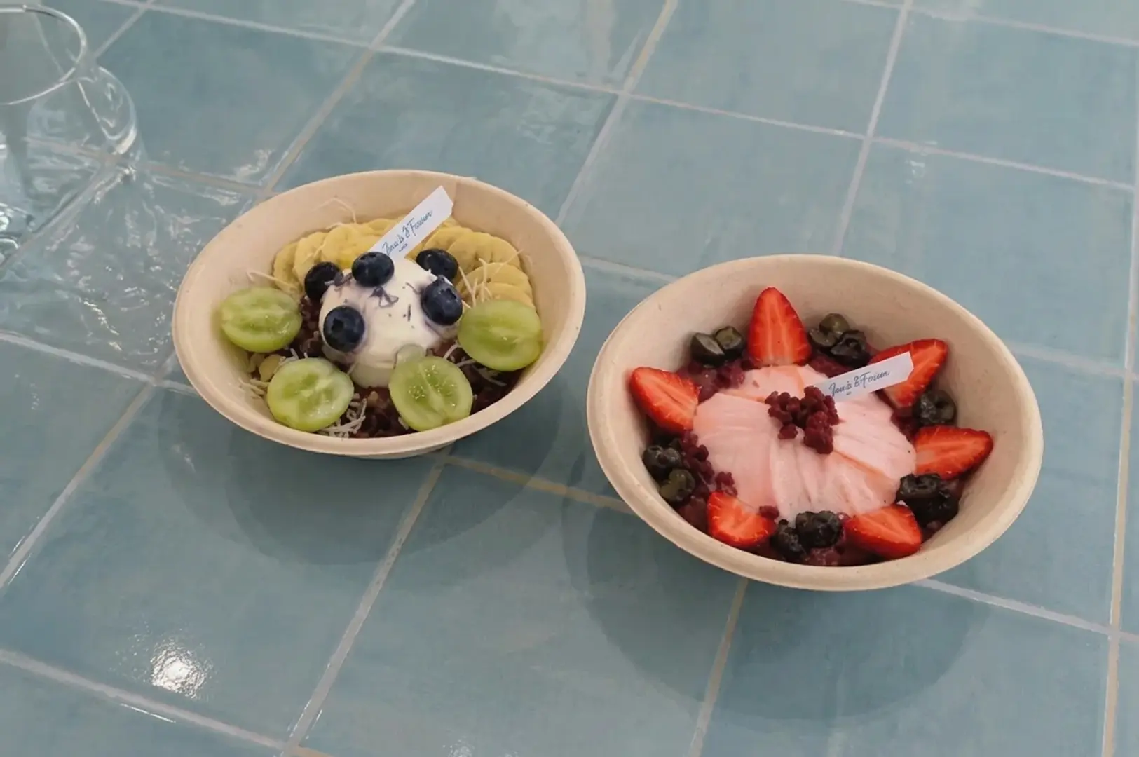 Two bowls of cold brew yoghurt bread topped with fresh fruits