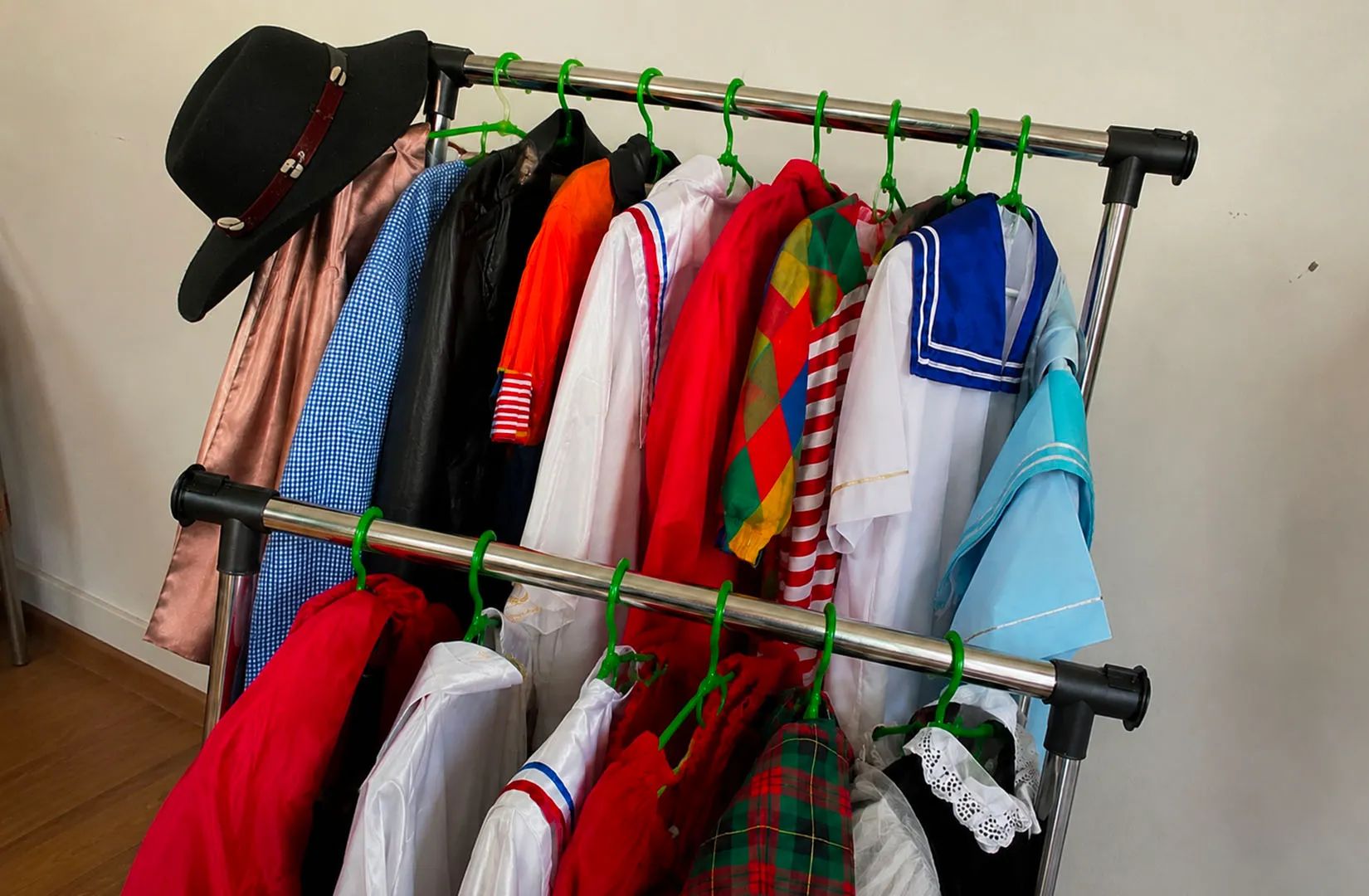 Colorful costume outfits displayed on a clothing rack.