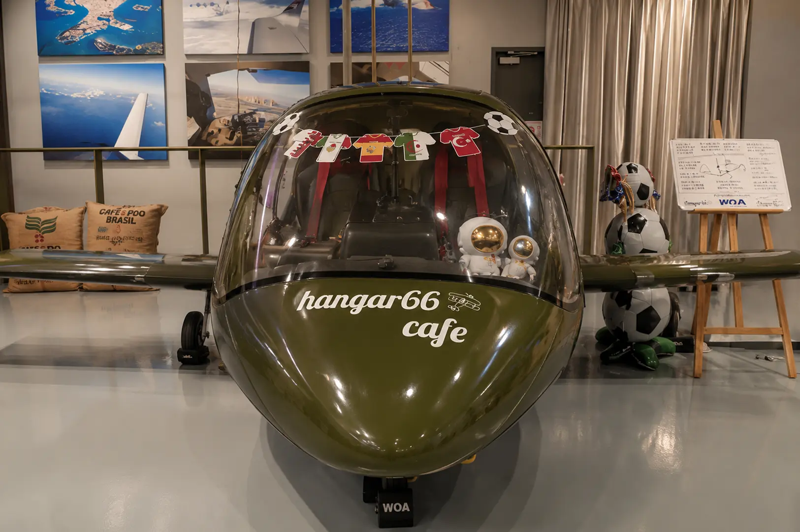 Front view of the helicopter centerpiece inside Hangar66 Cafe with aviation-themed decorations.