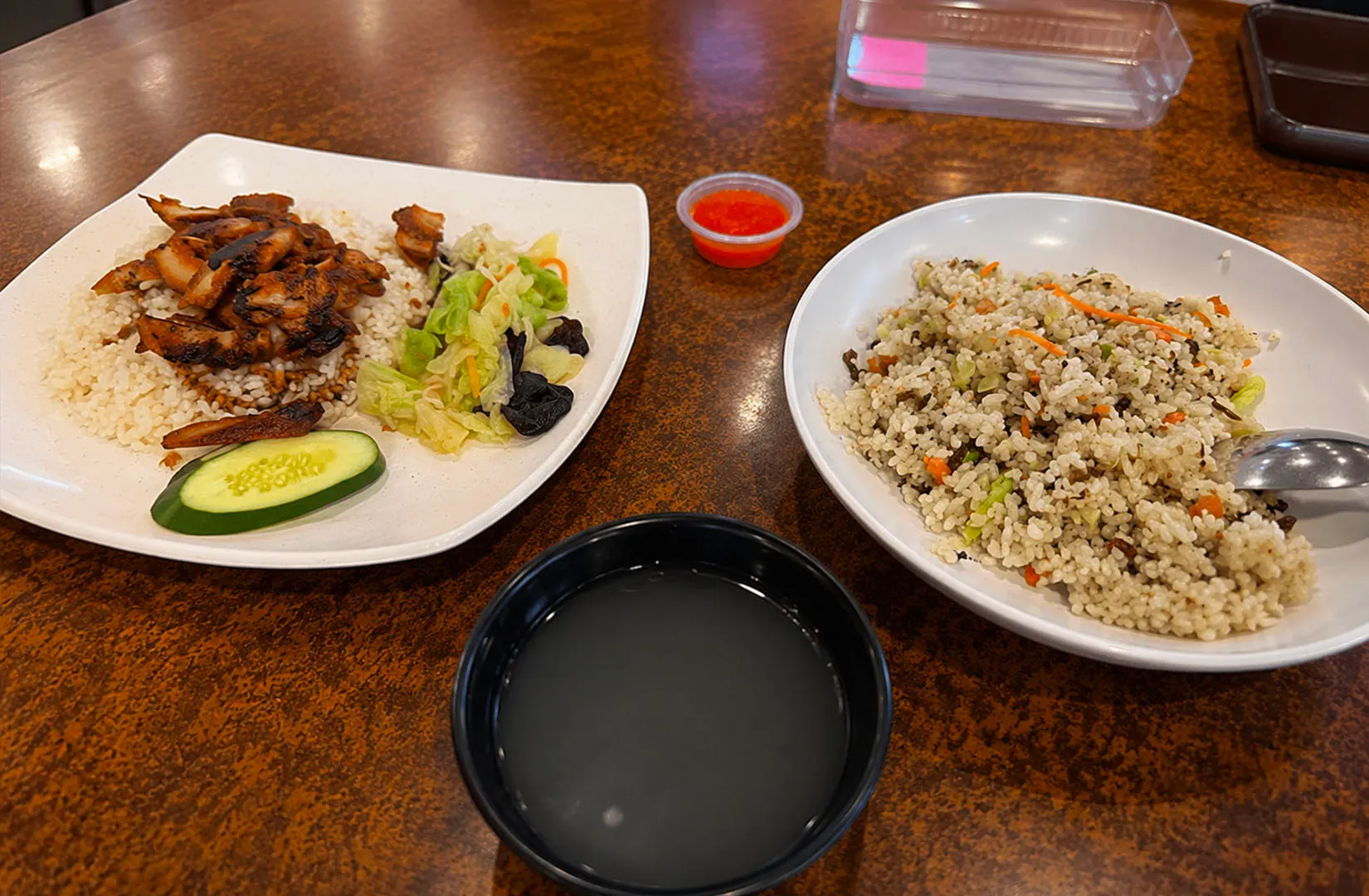 Chicken rice sets with soup, vegetables, and fried rice at Pine Tree Cafe