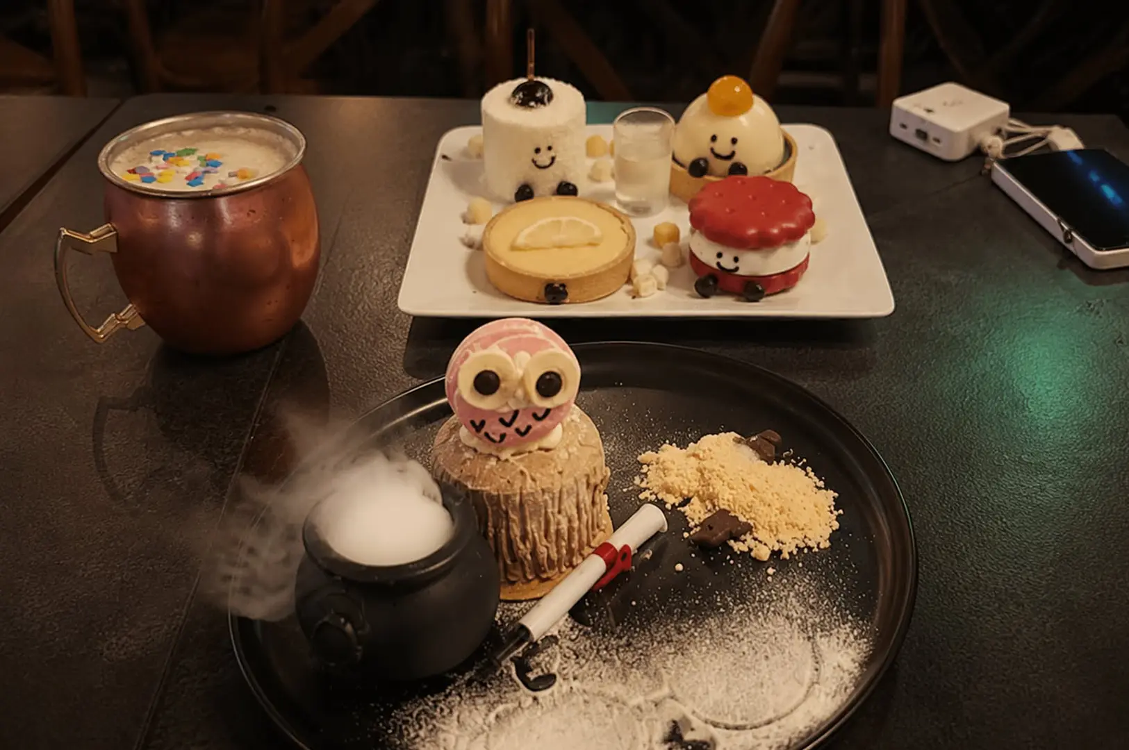 Magical dessert presentation with cute themed sweets and smoking cauldron effect.