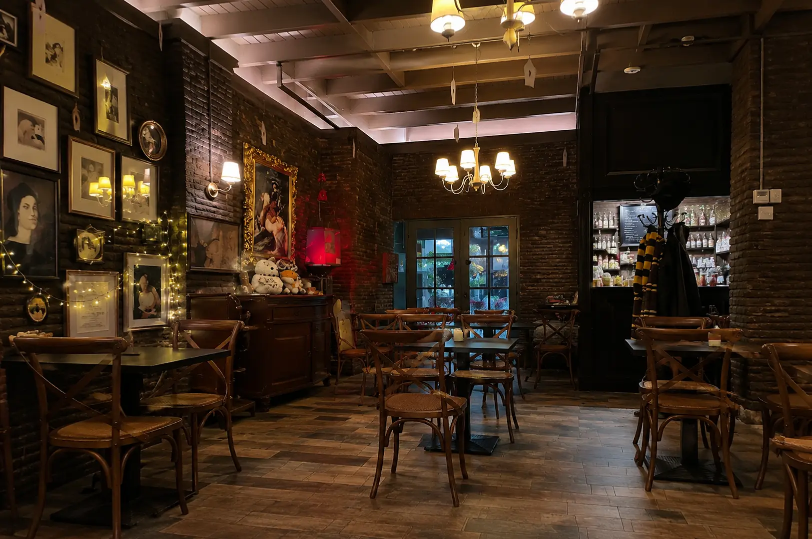 Wide view of Platform 1094 interior with brick walls, portraits, and cozy seating.