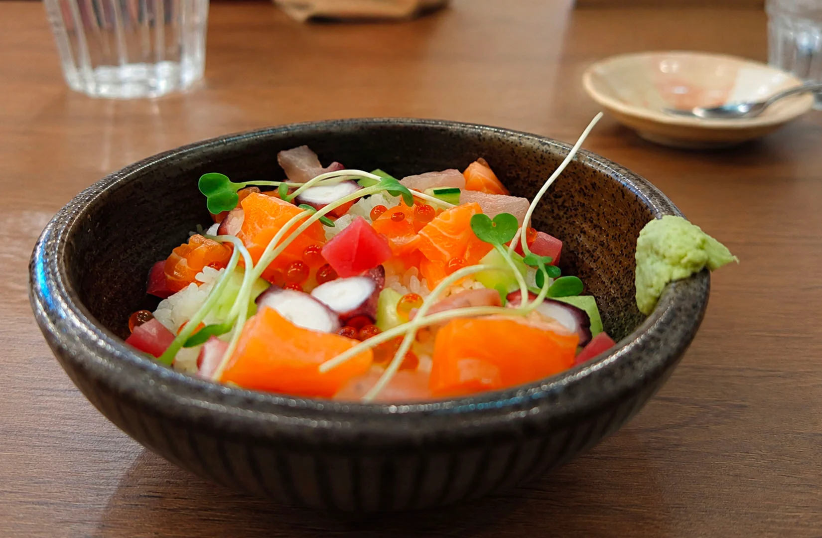 Fatty tuna chirashi bowl with minced tuna, salmon roe, tamago cubes, and sushi rice.