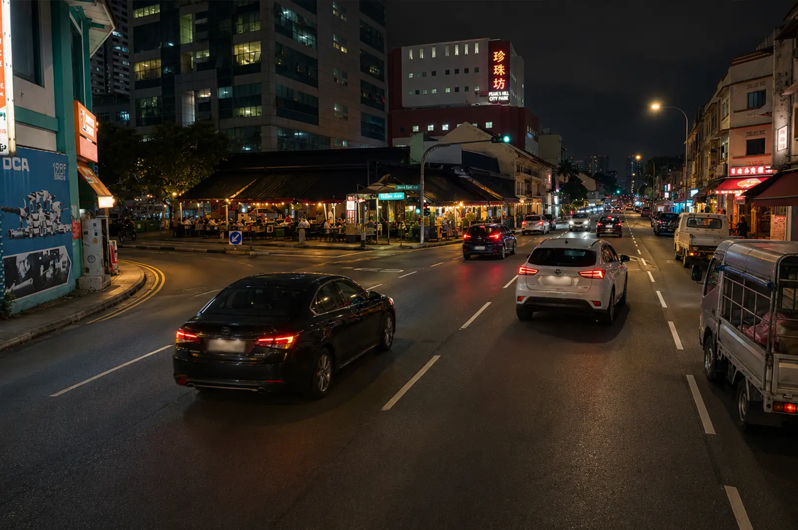 Nighttime street view with 126 Dim Sum and nearby restaurants along a busy road.