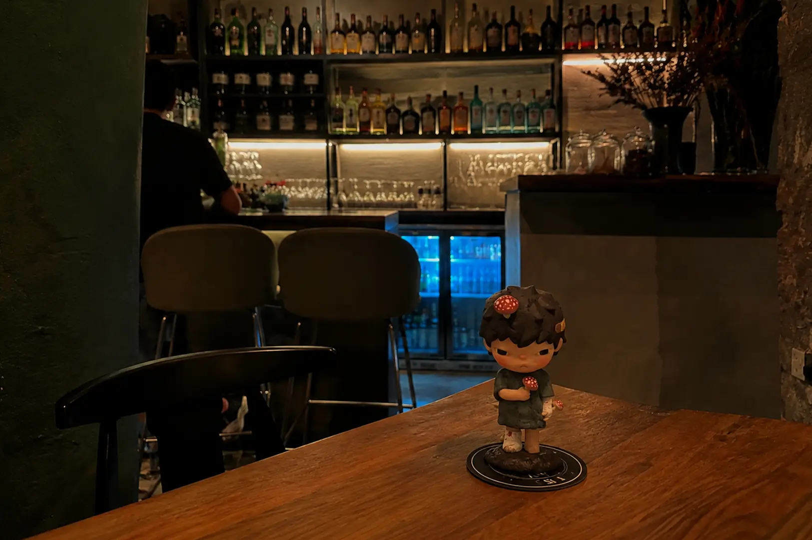 Cozy bar interior at Tess Bar & Kitchen with a decorative figurine on the table.