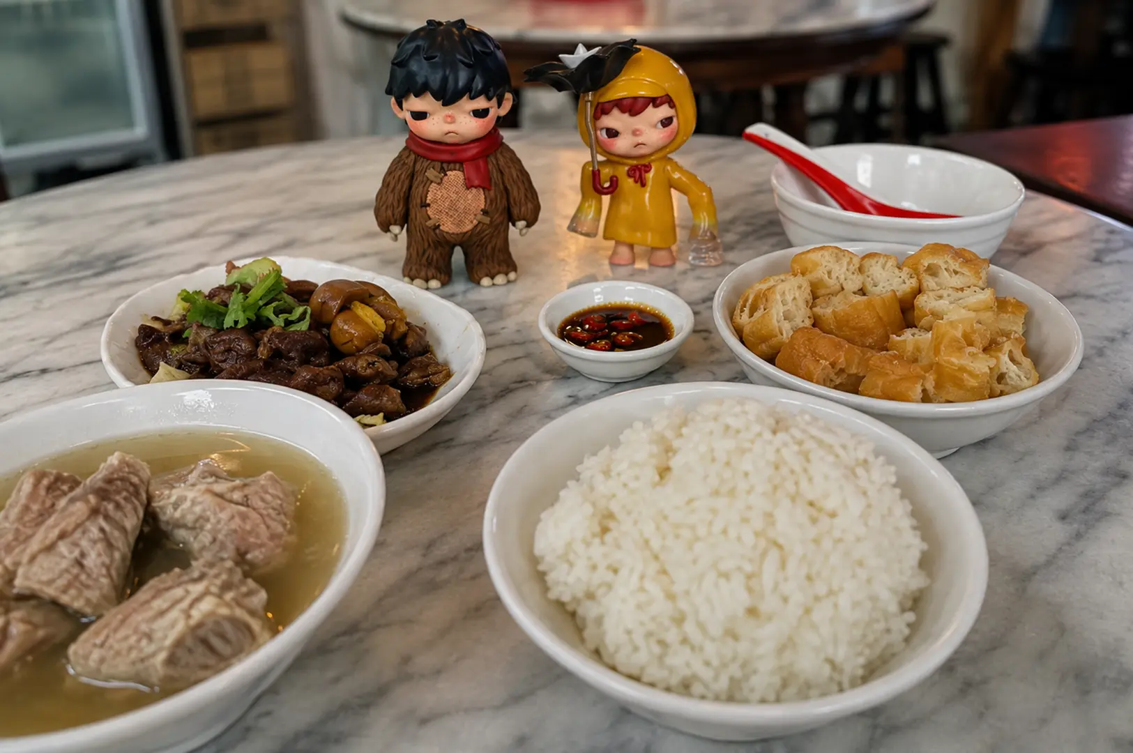A traditional Singapore bak kut teh meal with pork rib soup, rice, braised meat, fried dough and chilli soy sauce.
