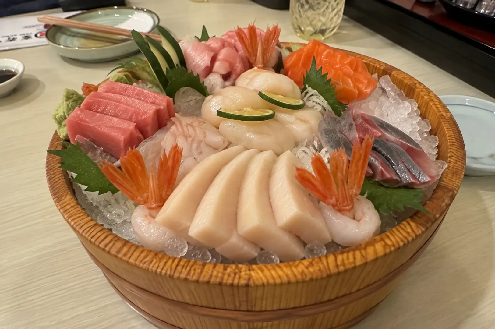 Assorted fresh sashimi served over crushed ice with tuna, salmon, scallops, shrimp and garnishes.