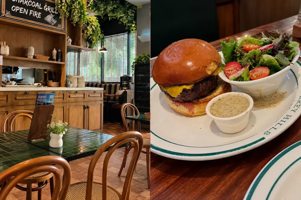 Surrey Hills Grocer interior with warm wooden furnishings, greenery, and a burger with salad on a plate.
