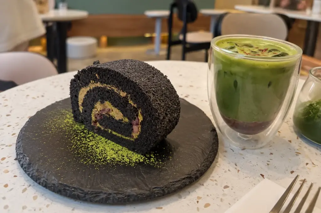 A matcha drink and dark dessert served together at a modern café, highlighting the familiar flavours seen across trendy café menus.