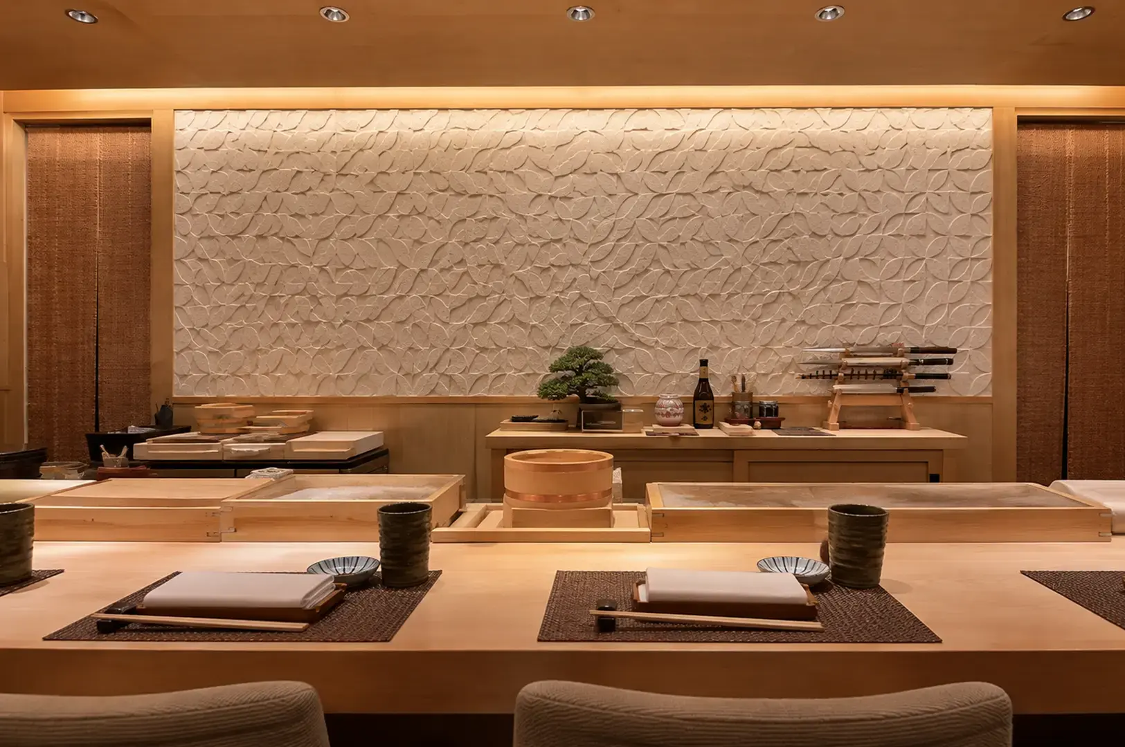 Intimate Japanese omakase counter with warm wood interiors and minimalist decor