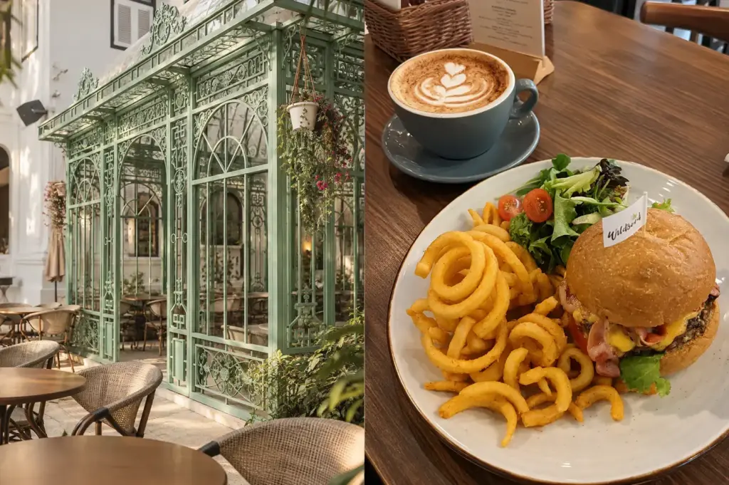 Wildseed Café featuring a charming green glasshouse exterior with hanging plants, outdoor tables, and café seating.