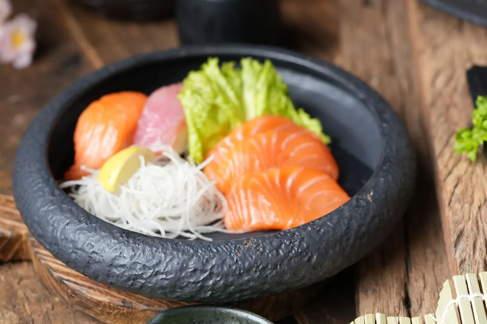 Japanese sushi spread featuring rolls, sashimi rice bowl, and specialty appetizers.