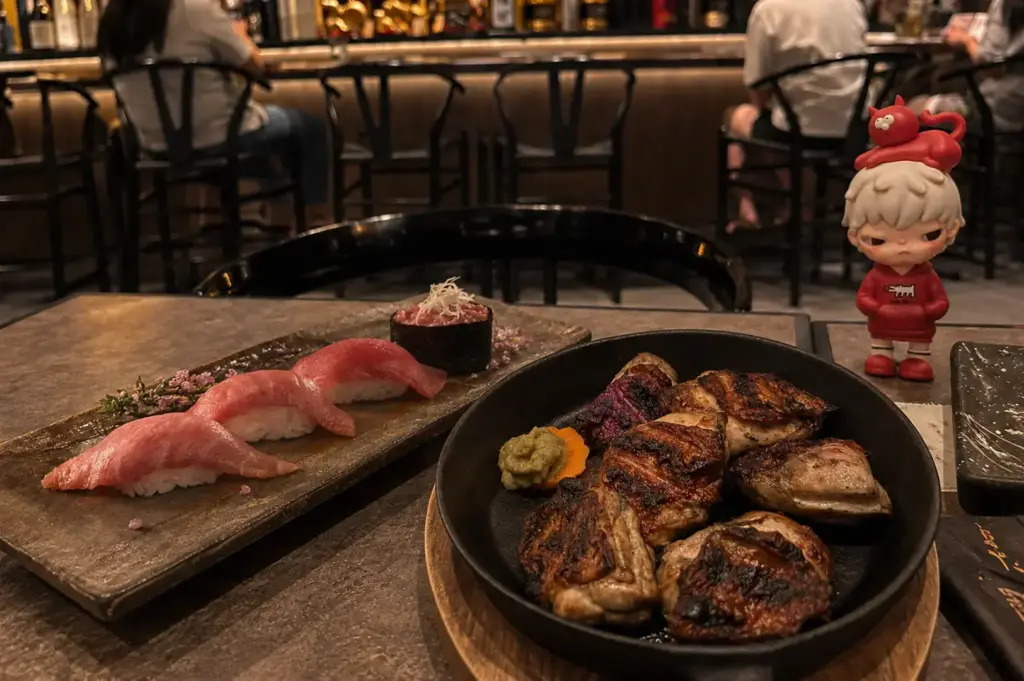 Sen-ryo aburi sushi platter served alongside assorted grilled dishes