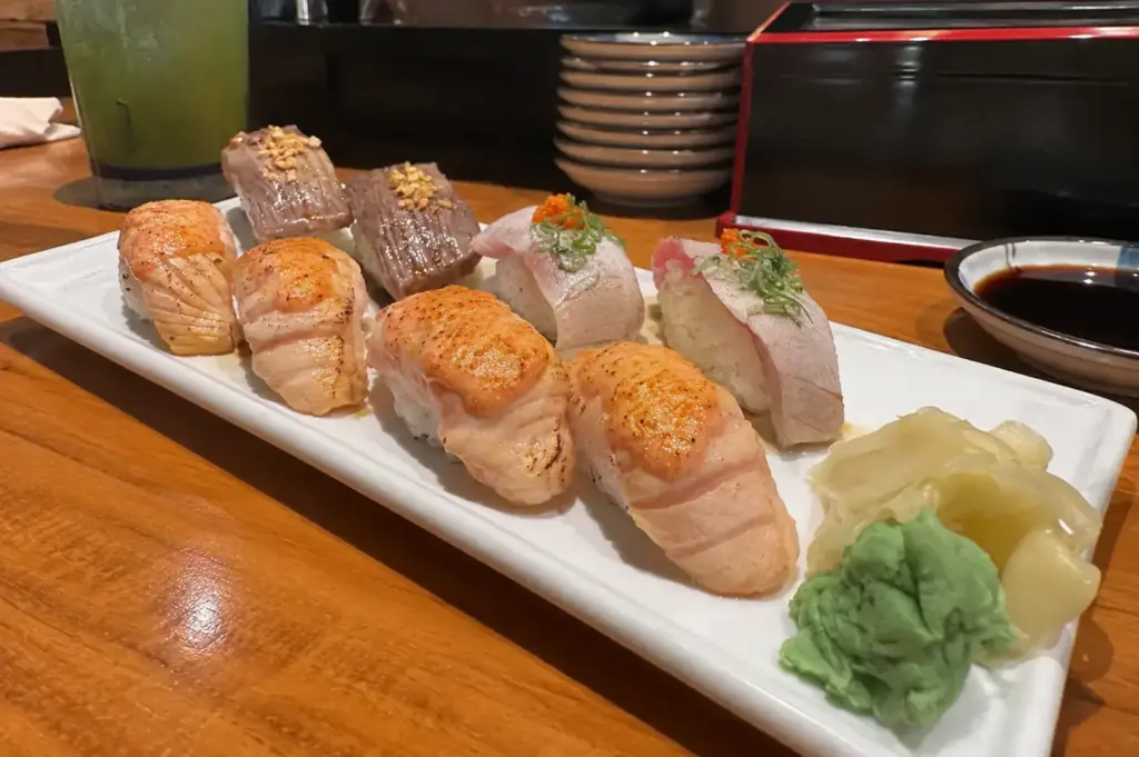 Aburi Omakase Set with assorted flame-seared sushi and wasabi