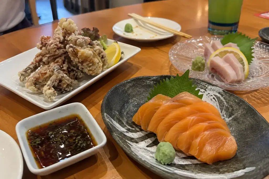 Salmon sashimi with fried seafood and additional sashimi dishes