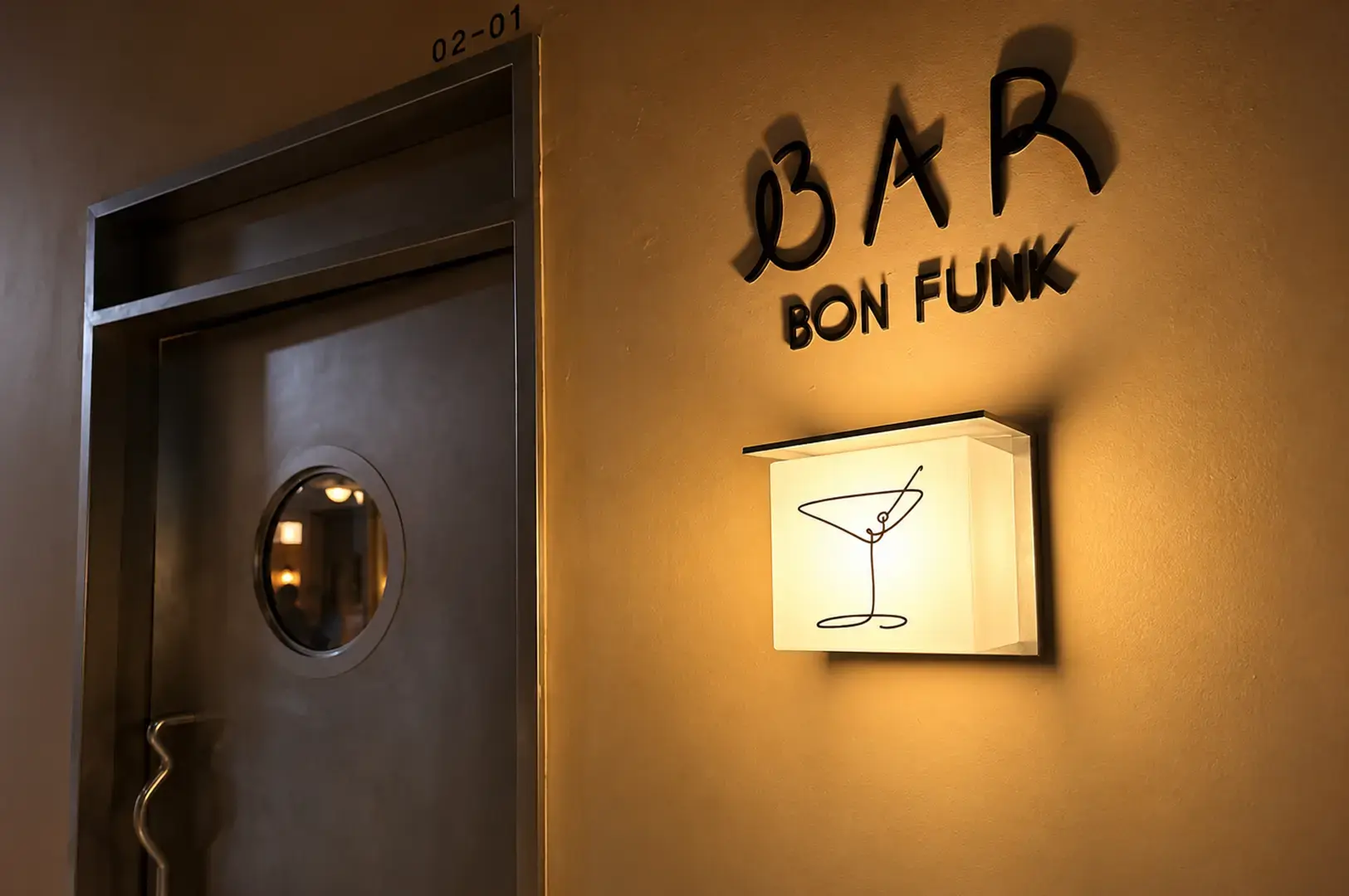 Entrance to Bon Funk bar with warm lighting and minimalist wall signage.