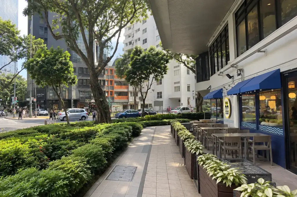 Fortune Centre’s outdoor walkway lined with trees, office buildings, and restaurant seating along the pavement.